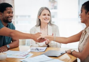 Finance, banking and loans, a handshake seal the deal for a happy, young startup entrepreneur. Meet